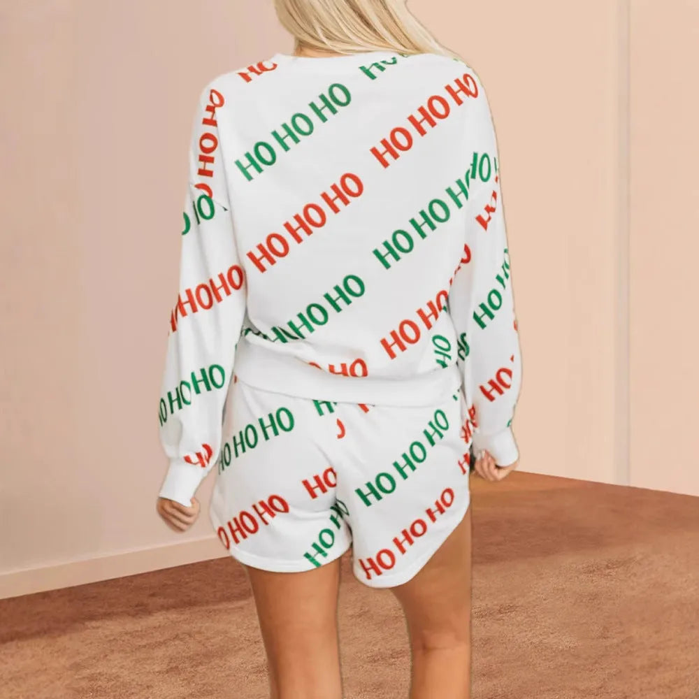 White women's two-piece suit with black letter and number print, featuring long sleeves and fifth-length trousers.