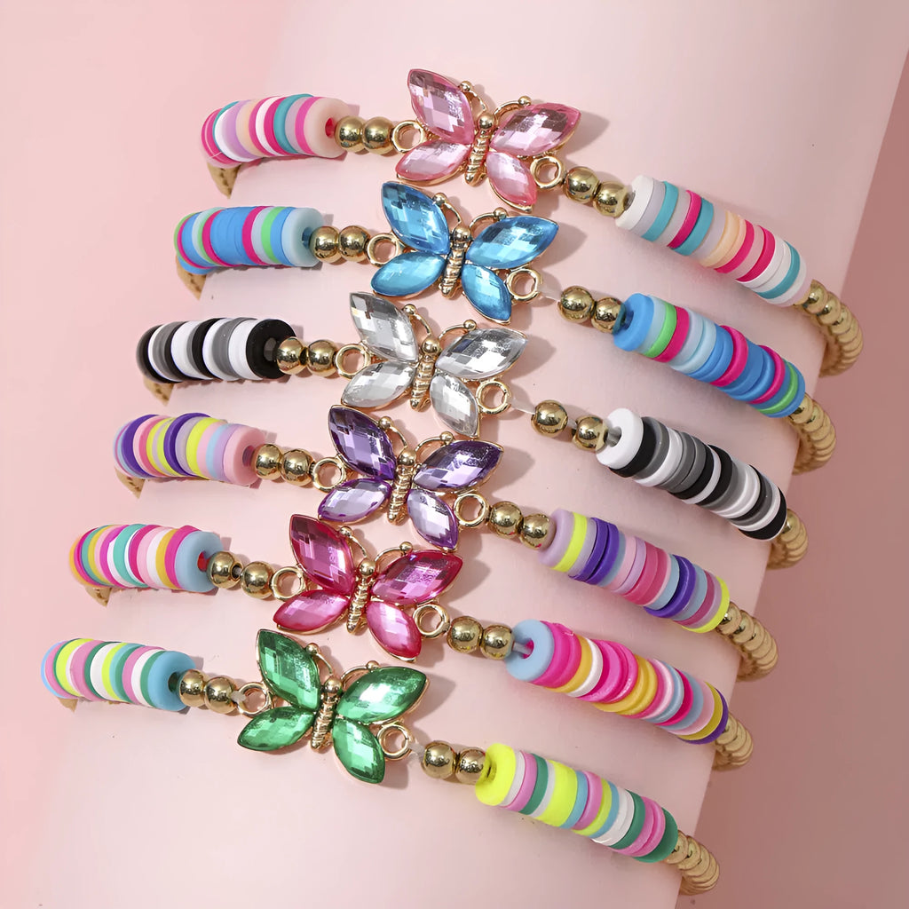 Children's polymer clay bracelet with dinosaur bead theme on a white background