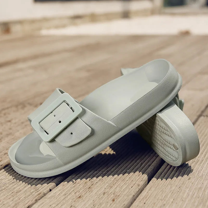 Women's grey blue buckle fastening flip-flop sandals with a soft EVA sole on a white background.