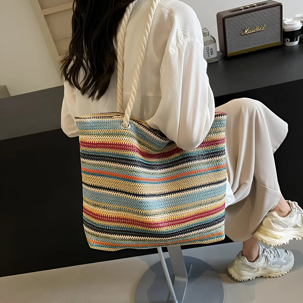 Blue straw woven nylon shoulder bag with a single strap and large main compartment