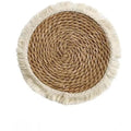 Japanese straw round placemat with tassel trim in natural papyrus material on dining table