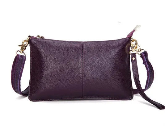Structured cowhide lady slant bag in apricot colour with hand strap and shoulder strap, showing slim profile.