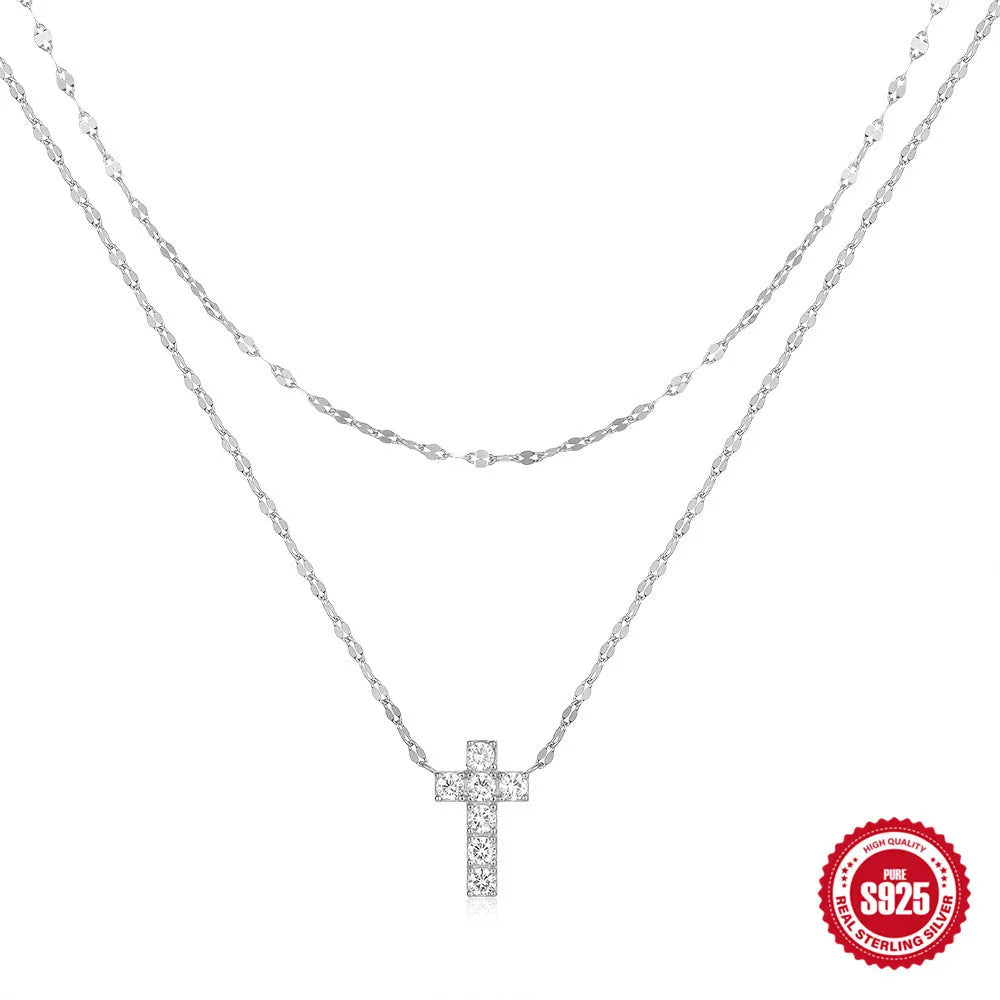 Double layer geometric twin diamond cross pendant on a sterling silver clavicle chain.