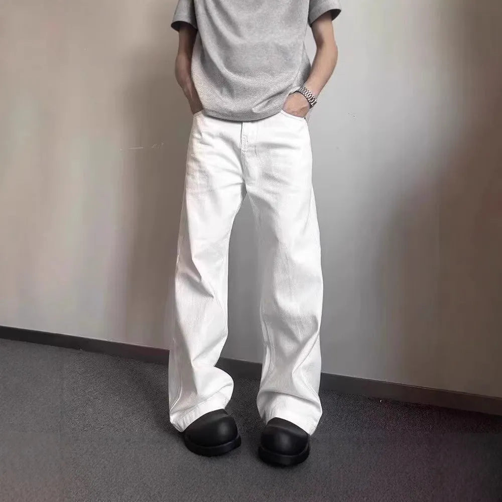 Men's white straight-leg wide-leg cotton denim jeans on a plain background.