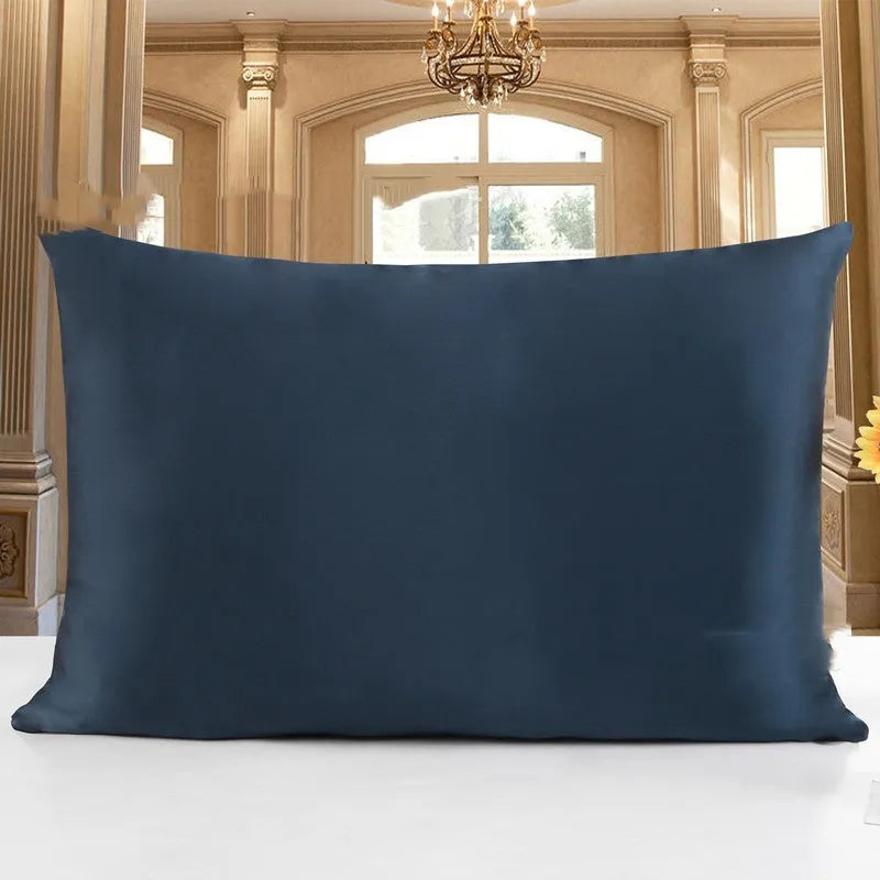 19 M double-sided silk pillowcase in apricot colour on a bed.