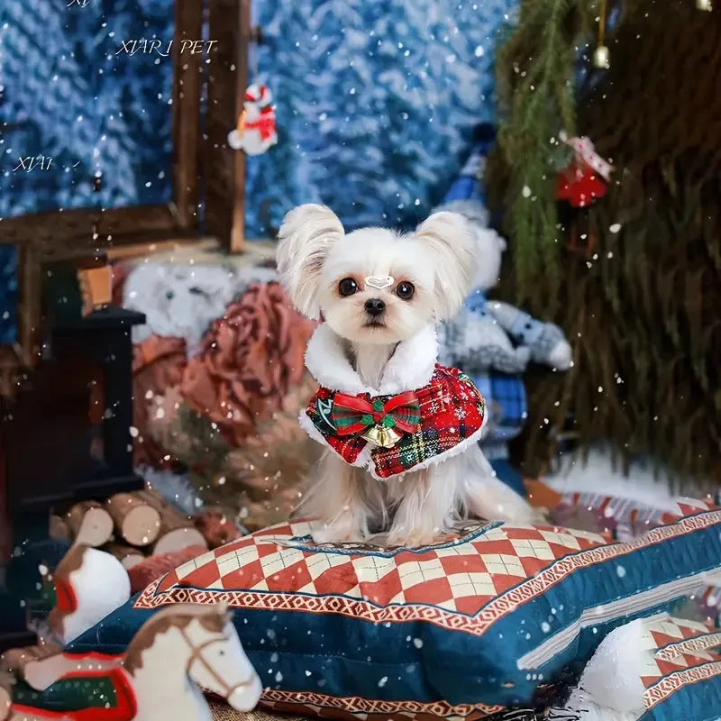 Polyester pet scarf cloak on a dog, showing a red background with a festive snowflake bell design.