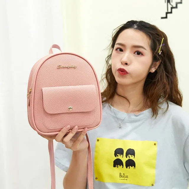 Women's small black PU backpack purse with letter design and zipper closure