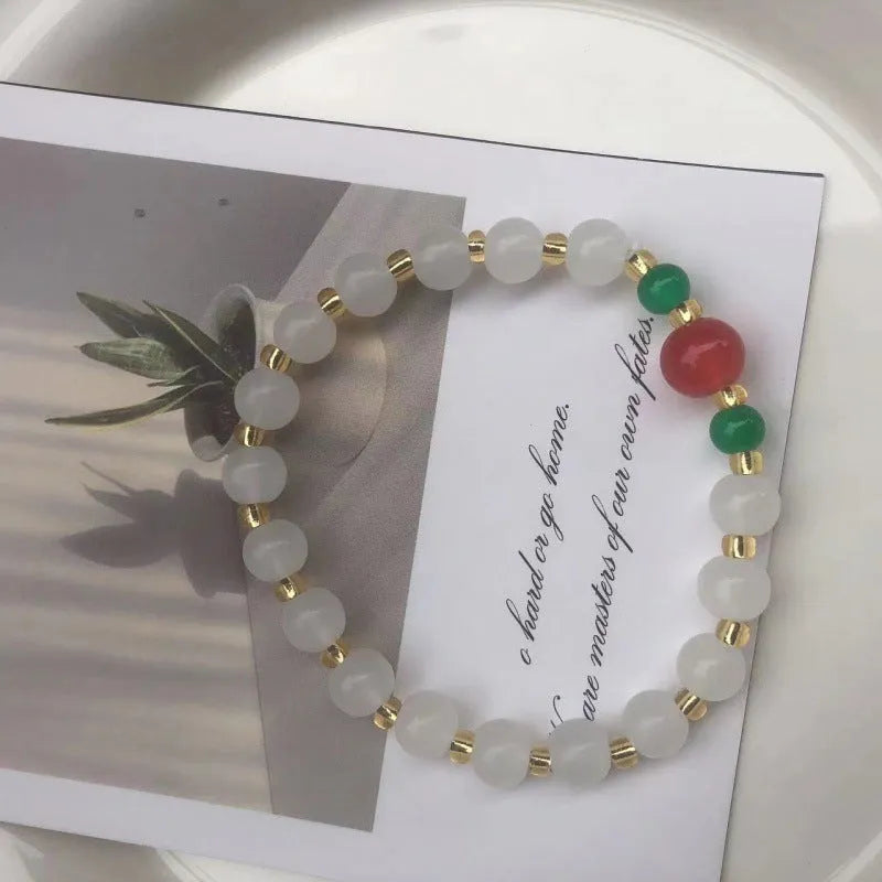 Chinese style glass bracelet with bamboo joint details in a red Lvzhu Duobao design.