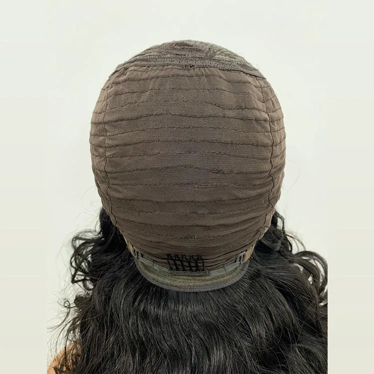 Ombre curly human hair lace wig in black with oblique bangs on a mannequin head