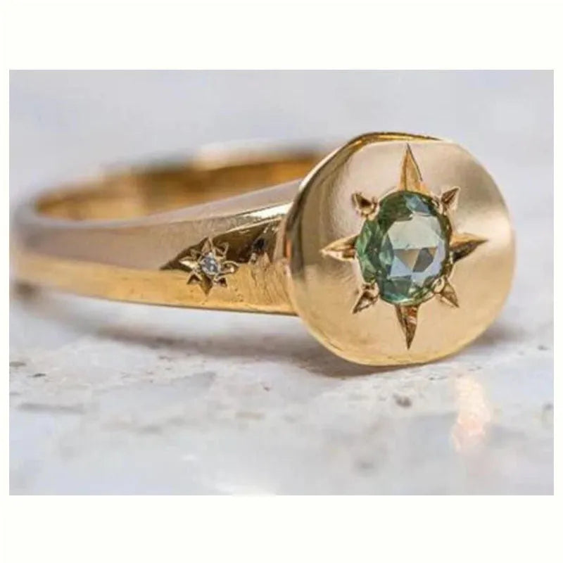 Golden adjustable ring with oval zircon centrepiece and star pattern detail