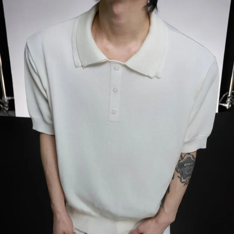 Man wearing a grey short sleeve shirt with a distinctive double collar lapel design.