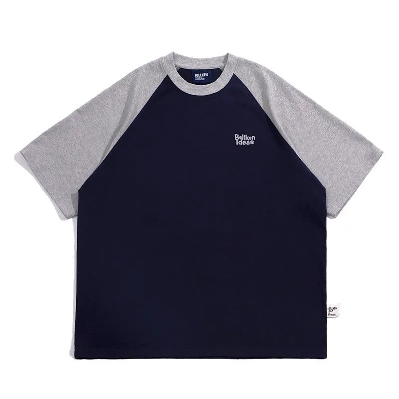 Blue loose-fit men's raglan sleeve T-shirt on a hanger, front view.