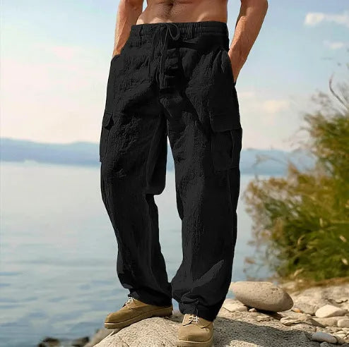 Men's loose cotton wide-leg casual trousers in light army green colour on a hanger.