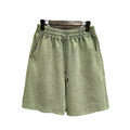 Men's solid colour cotton shorts with distressed detailing on the leg, shown in a loose, straight-leg fit.