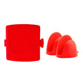 Red silicone baking tray and oven gloves set on a kitchen counter.