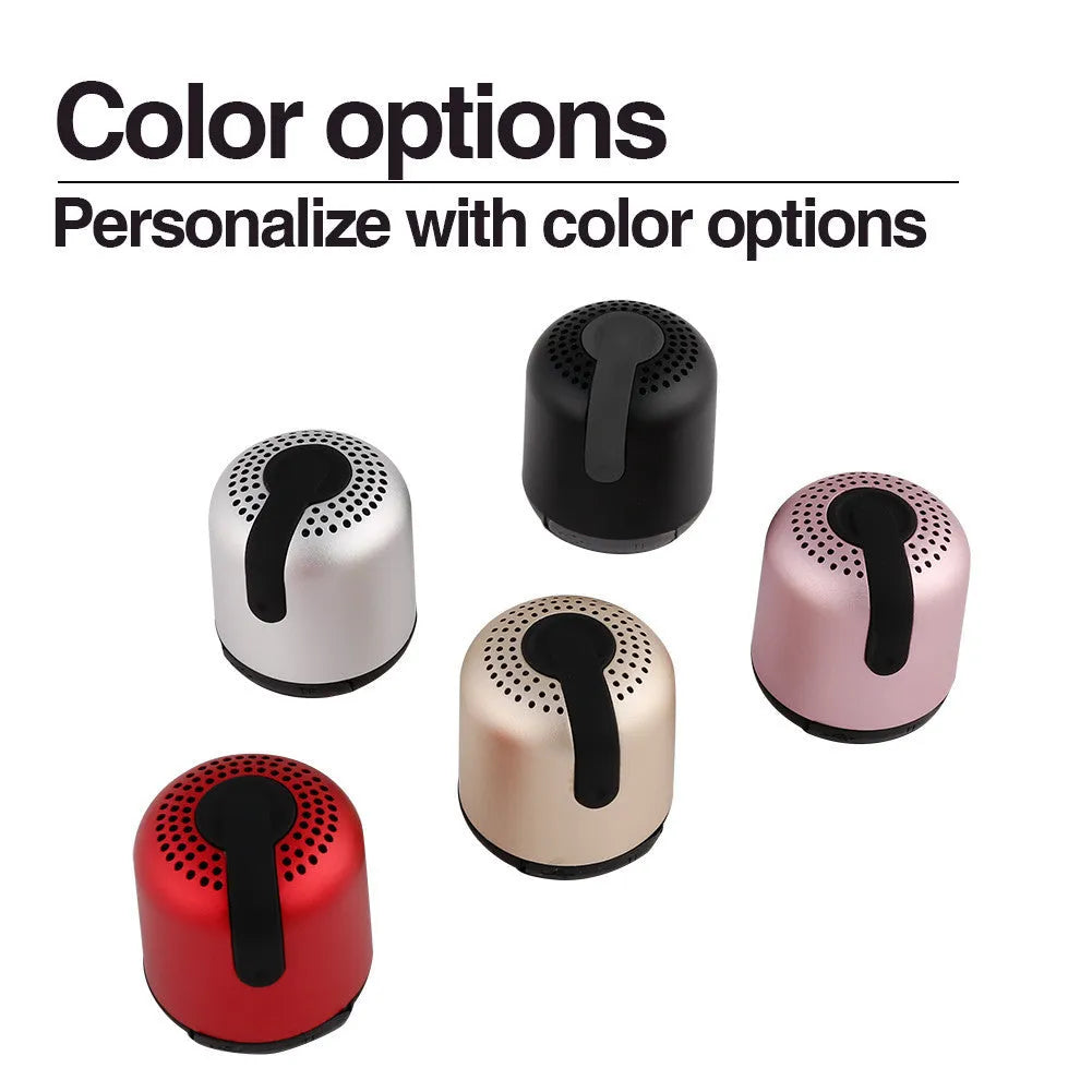 Hieha XQ11 cylinder-shaped mini portable Bluetooth speaker in metallic colour on a table.