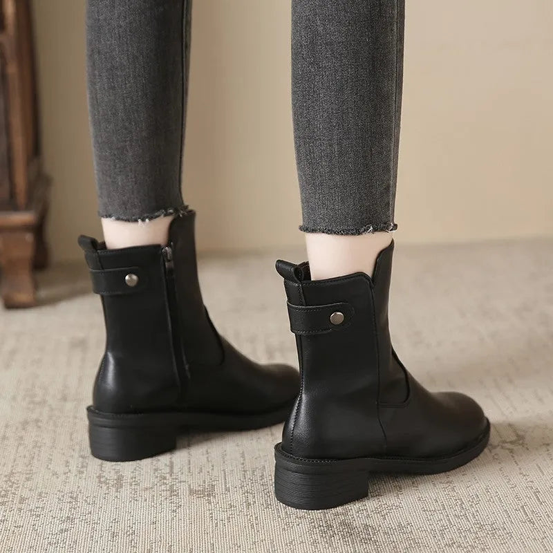 Black women's short boots with side zip and round toe on a low rubber sole.