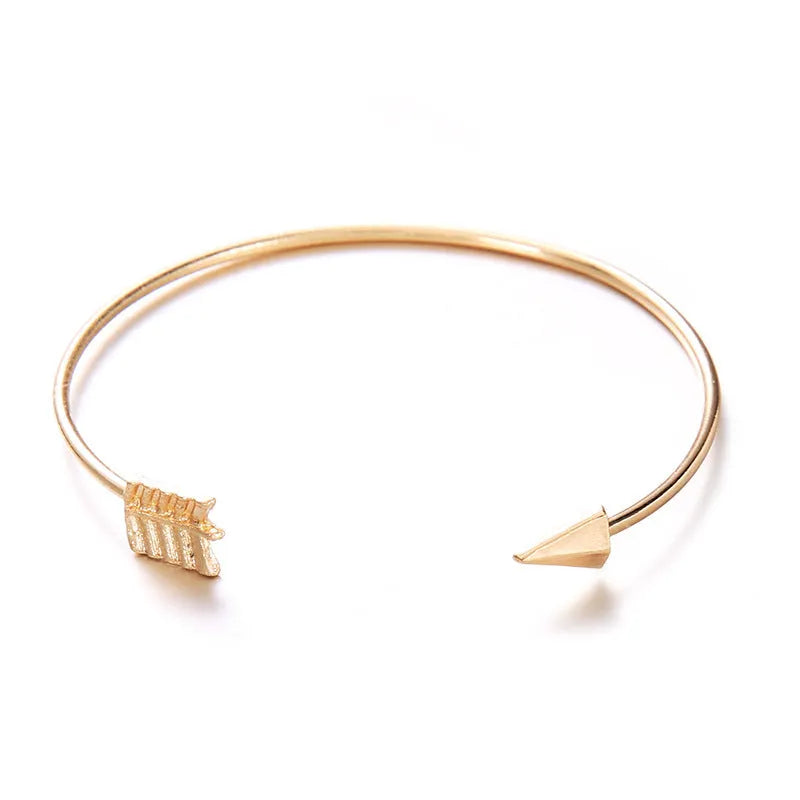 Gold electroplated alloy vintage cuff bracelet with arrow and knot design for women