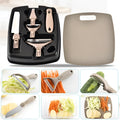 Green stainless steel cutter set with wheat straw chopping board, peeler, and fruit knife on a table