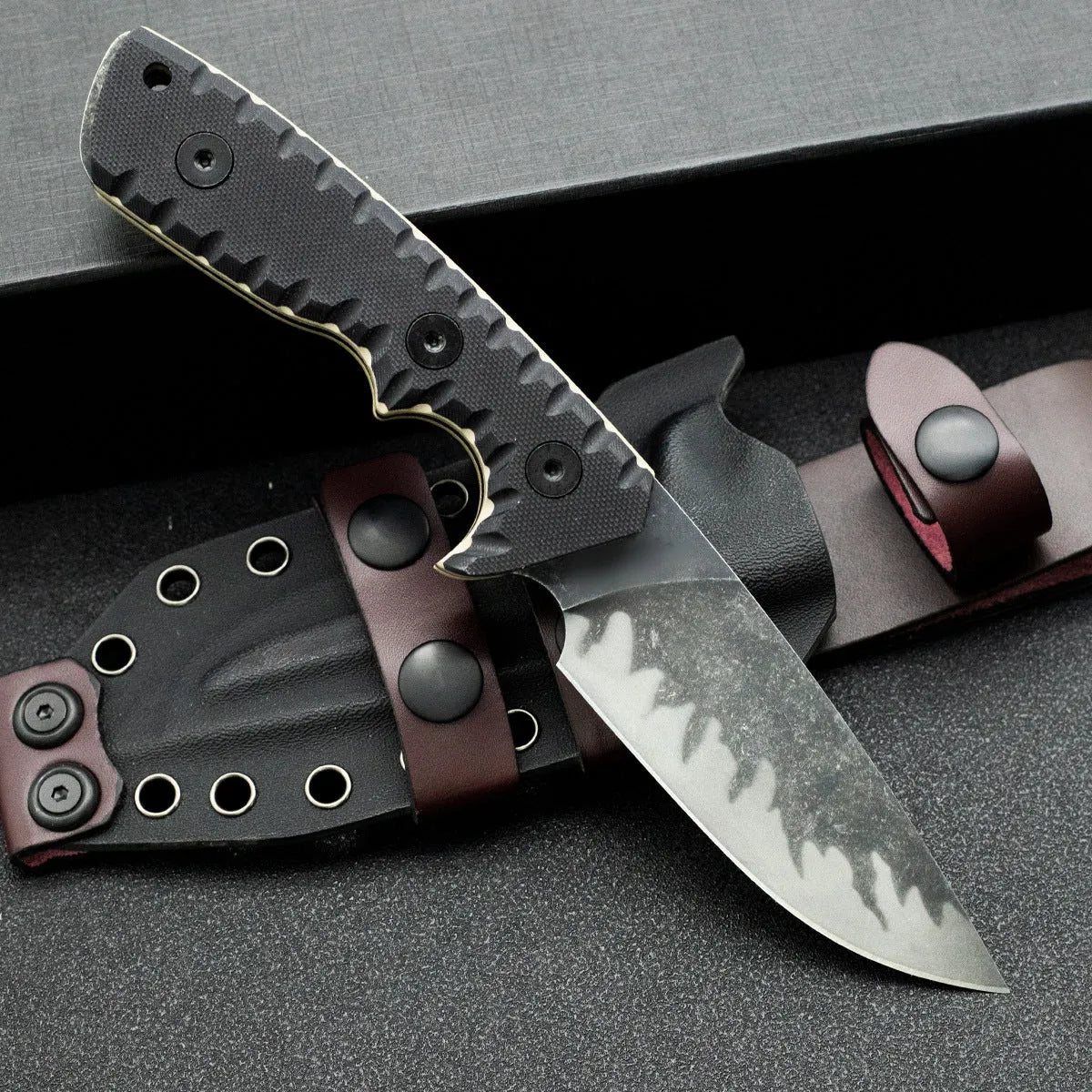 Portable camping knife with black handle and 100mm blade on plain background