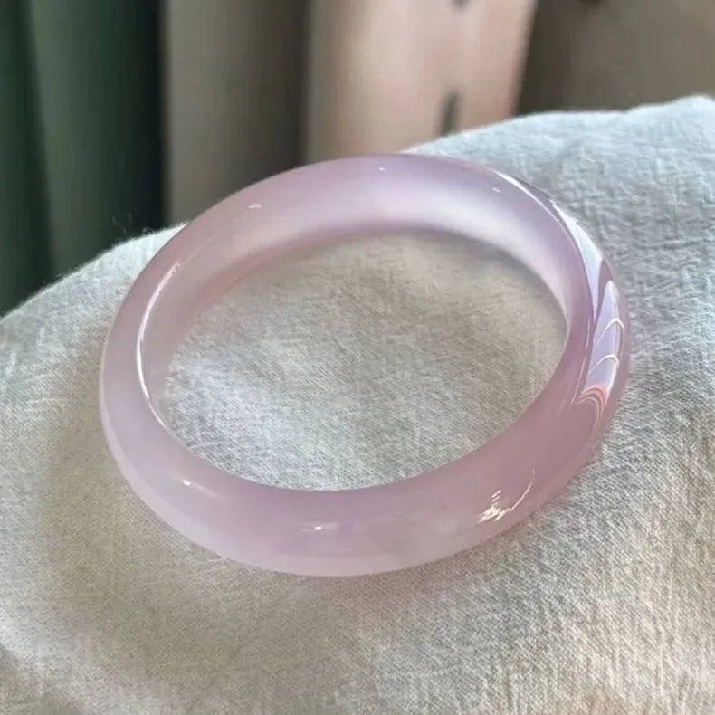 Natural agate wide tire bracelet in pink stone with size options from 52 to 62 mm circumference.