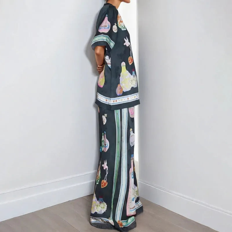 Black women's casual set with cartoon print, showing cardigan and matching trousers