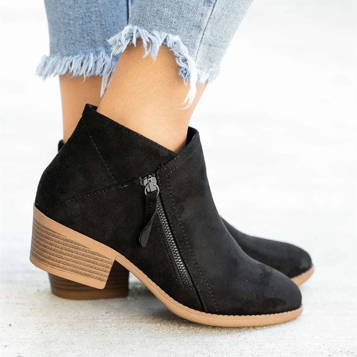 Blue suede women's ankle boots with a chunky heel and side zip closure on a white background.