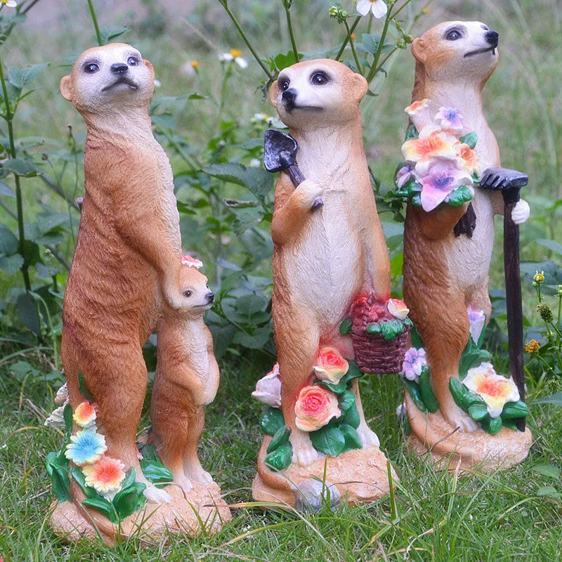 Three resin mongoose garden ornaments with straw hats, including figures holding rake and shovel tools