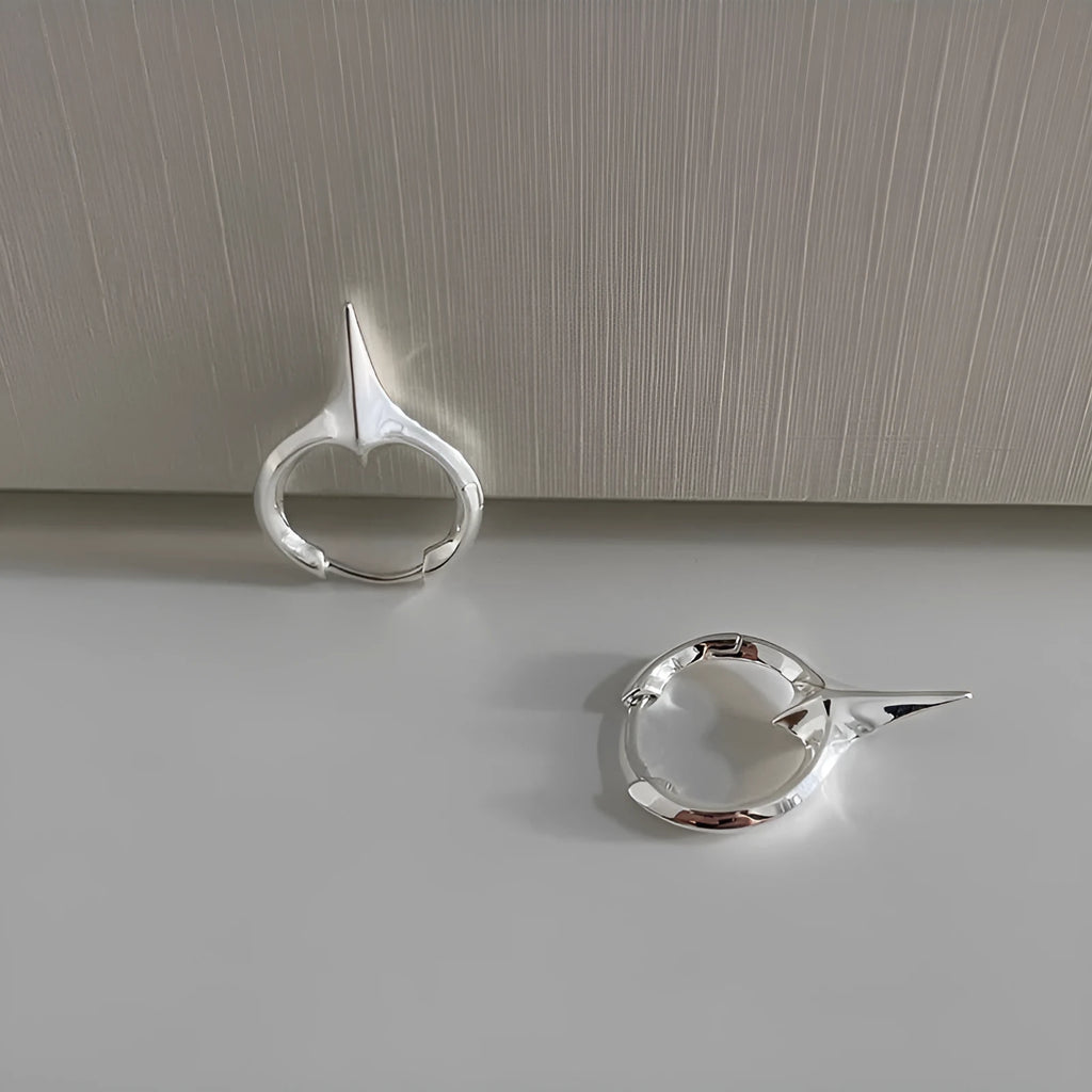 A pair of gold and white electroplated geometric star ear clips made from solid copper for women.