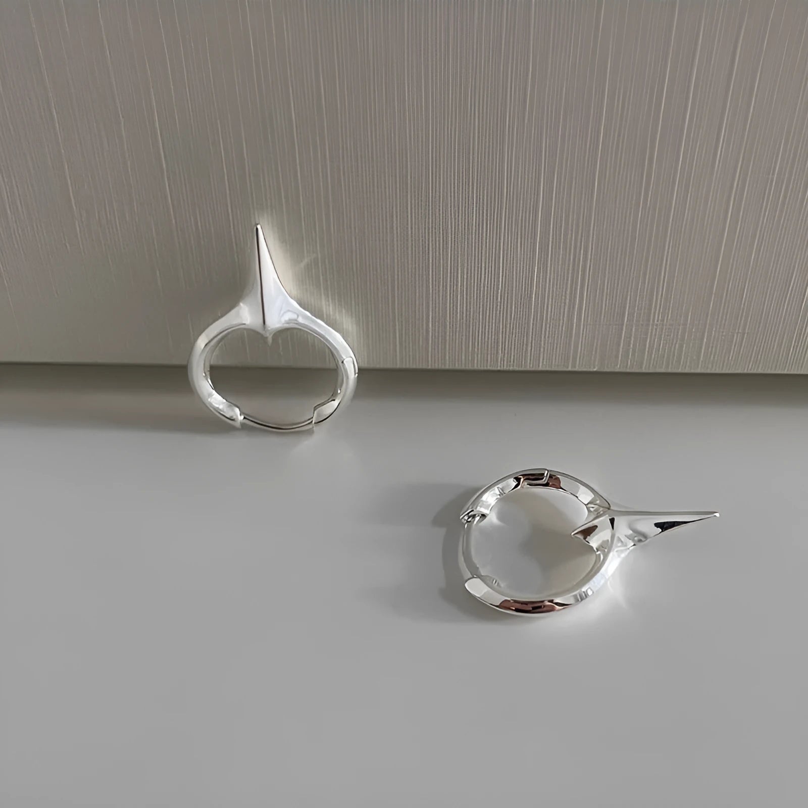 A pair of gold and white electroplated geometric star ear clips made from solid copper for women.