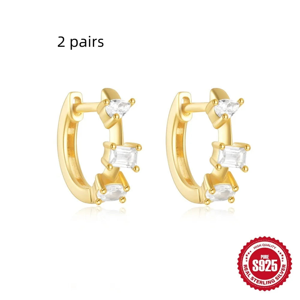 Small round geometric sterling silver stud earrings in gold and silver electroplated finishes.