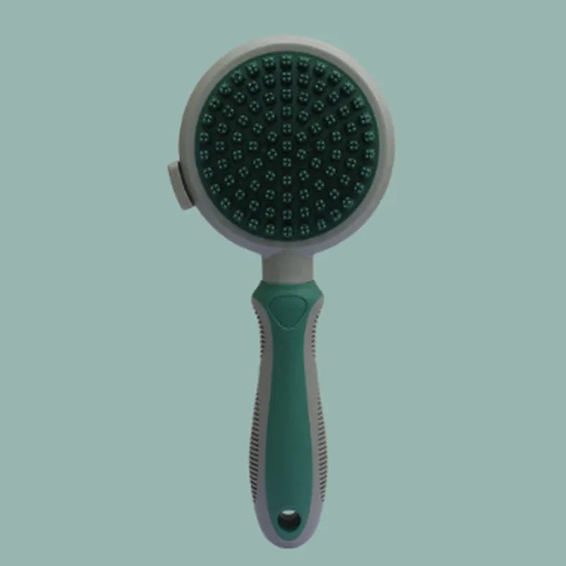 Two-sided silicone cat brush with green handle, showing slicker brush and massage sides