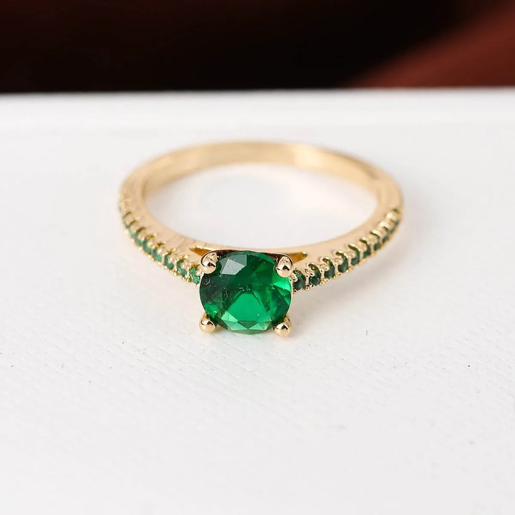 Hexagonal geometric copper ring with zircon electroplating in a gold rose red finish on a hand.
