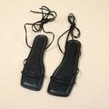 Women's white ankle strap flat sandals with lace-up front and square toe on a rubber sole.