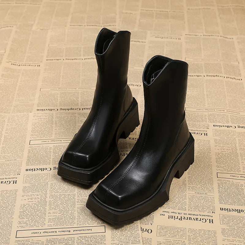 Black women's platform Martin boots with square toe and back zipper, showing mid-calf height.