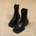 Black women's platform Martin boots with square toe and back zipper, showing mid-calf height.