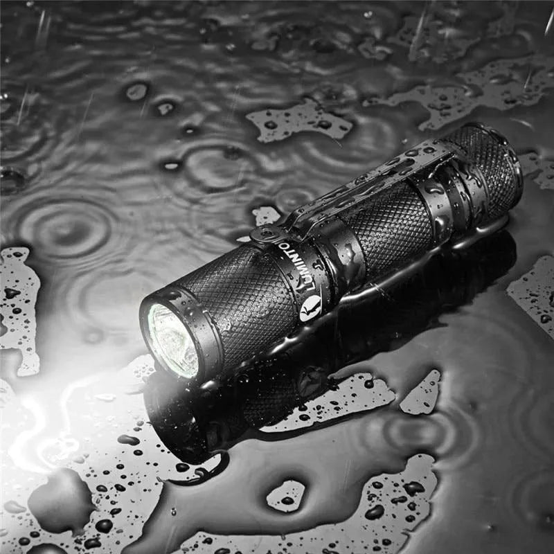 Lumintop Tool AA2.0 black compact keychain flashlight with Cree LED on metallic background