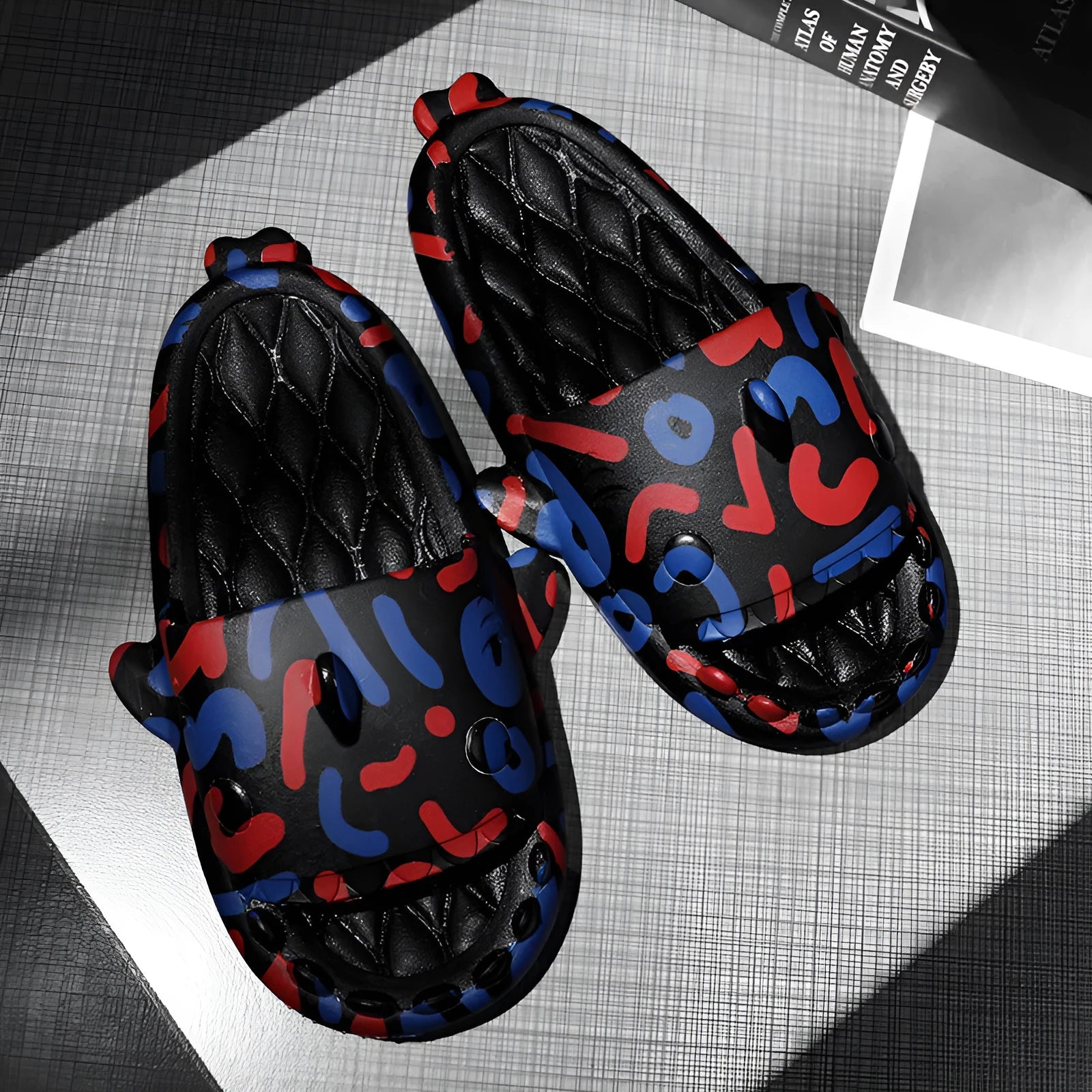 Beige and black EVA open-toe home slippers with a shark design on the front, shown as a couple's pair.