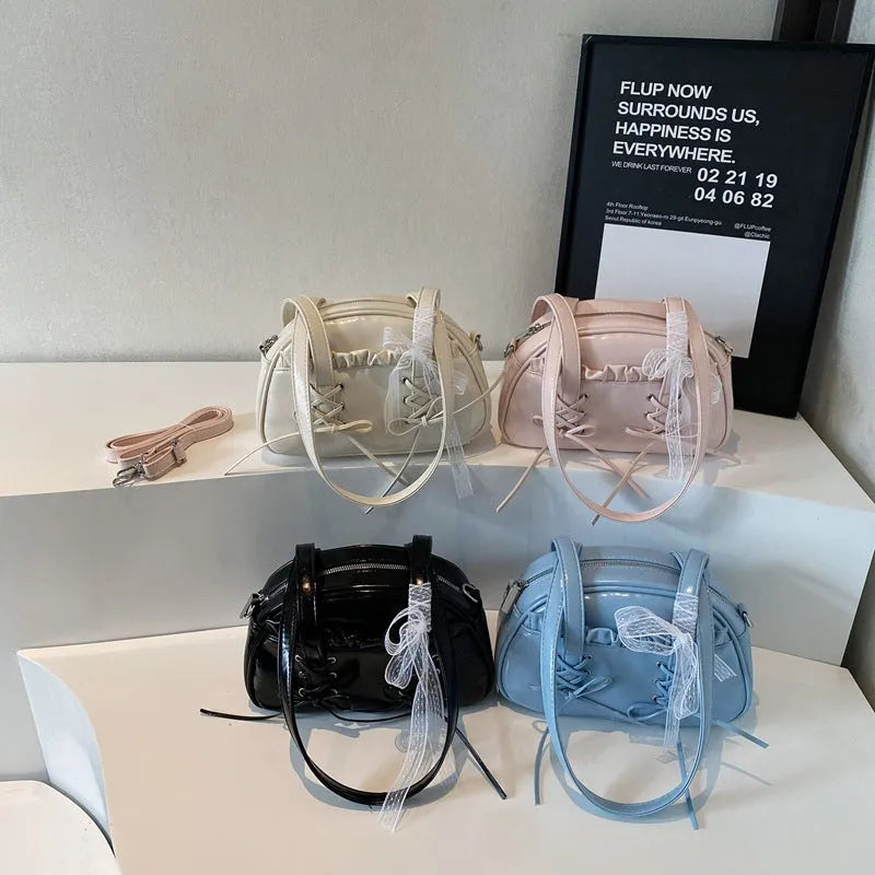 Ladies shoulder handbag with bandage bow design in PU leather showing phone pocket compartment