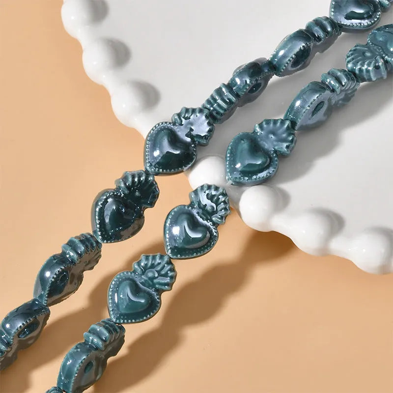 Ceramic heart torch beads in various colours for jewellery making, approximately 10mm by 15mm with straight hole