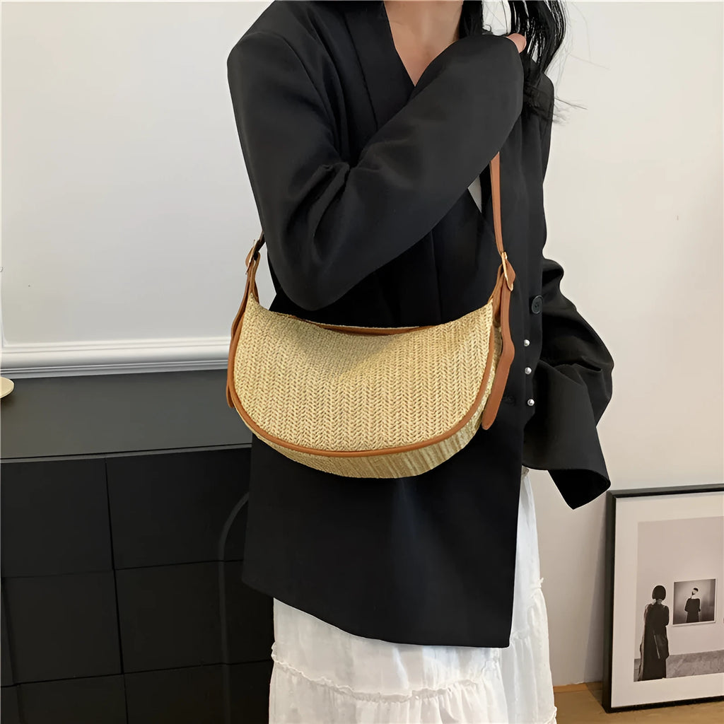 Straw woven crossbody bag showing woven texture and interior phone compartment