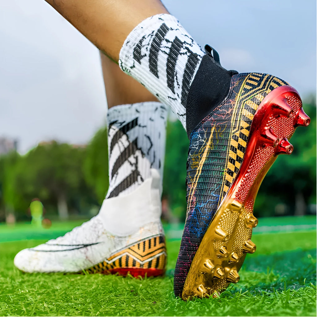 Men's high-top football training shoes with a gold-plated sole on an artificial grass surface