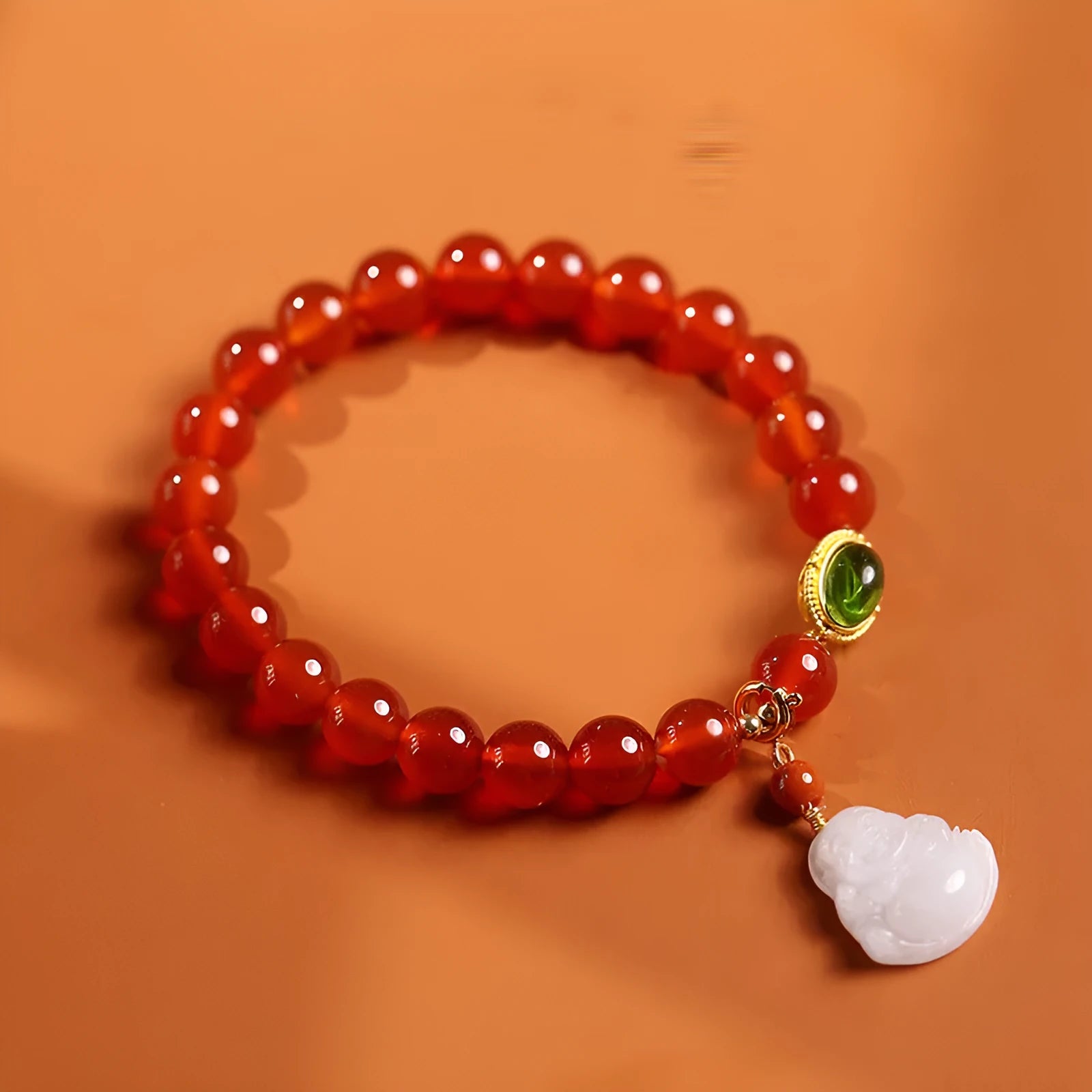 Women's handcrafted amber bracelet with red agate stones and gold Maitreya Buddha jade pendant