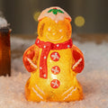 Glowing plastic gingerbread man Christmas ornament with a scarf in one of four colour options.