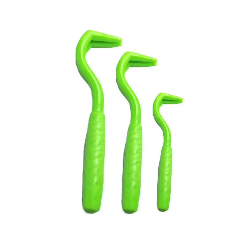 Three plastic tick removal hooks for dogs in assorted colours on a white background.