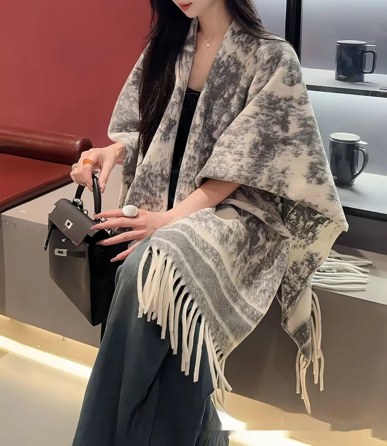 Women's casual polyester scarf cape with tassels worn as a shawl.