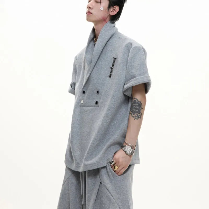 Men's dark grey cotton sports suit with metal embellishments, V-neck design, and padded shoulders