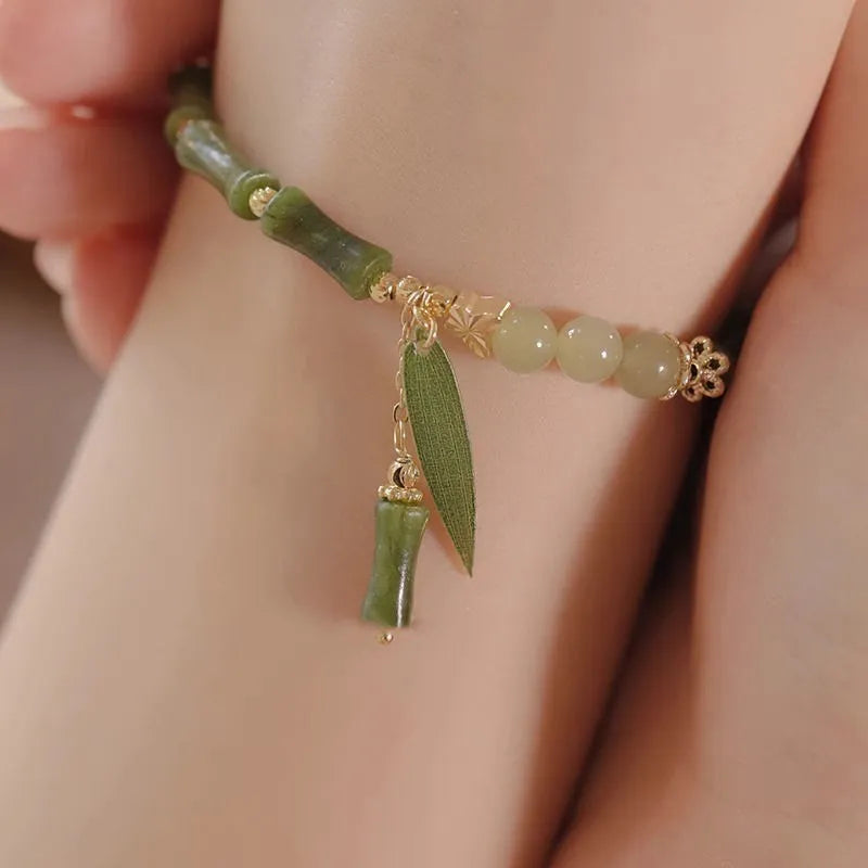 Chinese style glass bracelet with bamboo joint details in a red Lvzhu Duobao design.