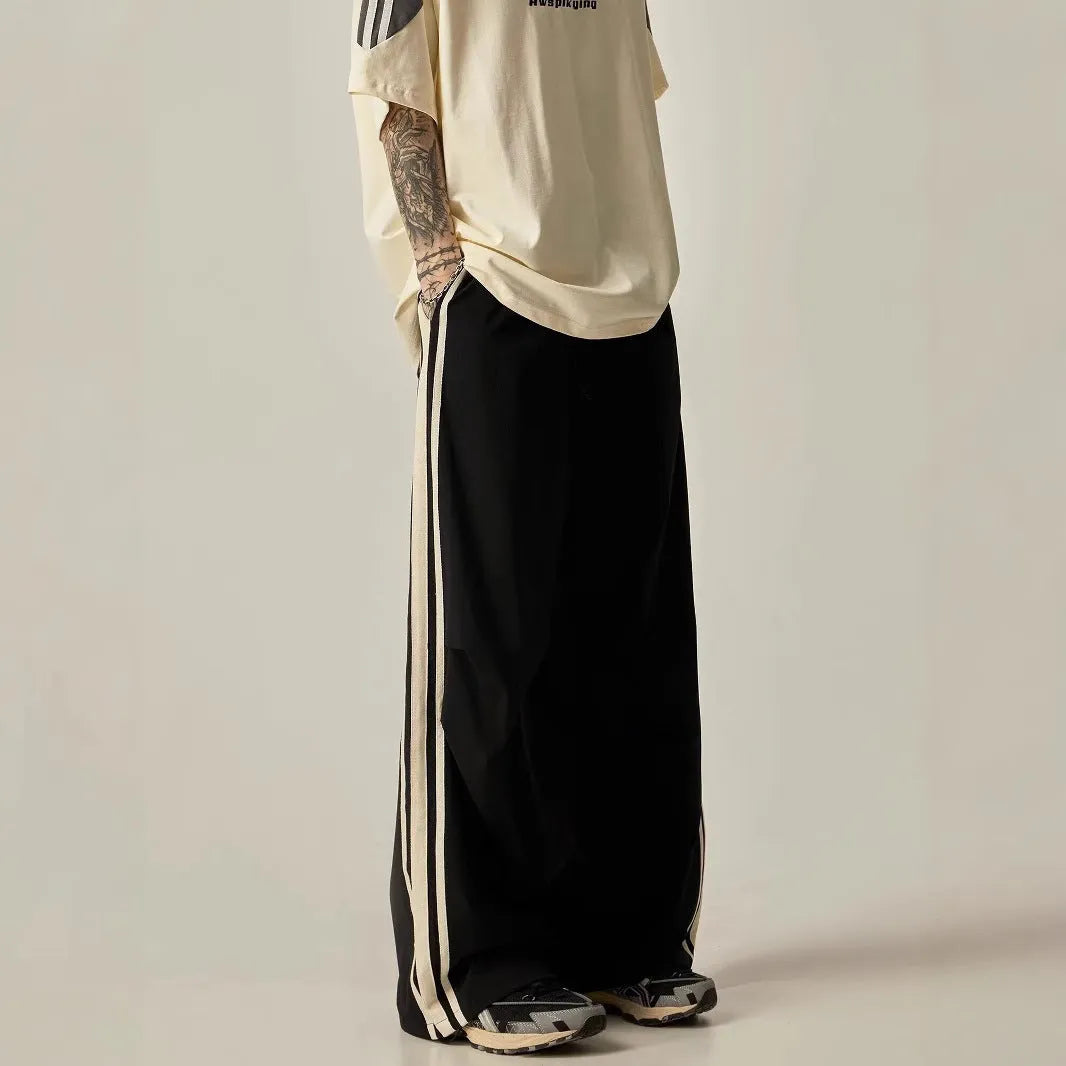 Man wearing black high-waisted straight-leg casual climbing trousers.
