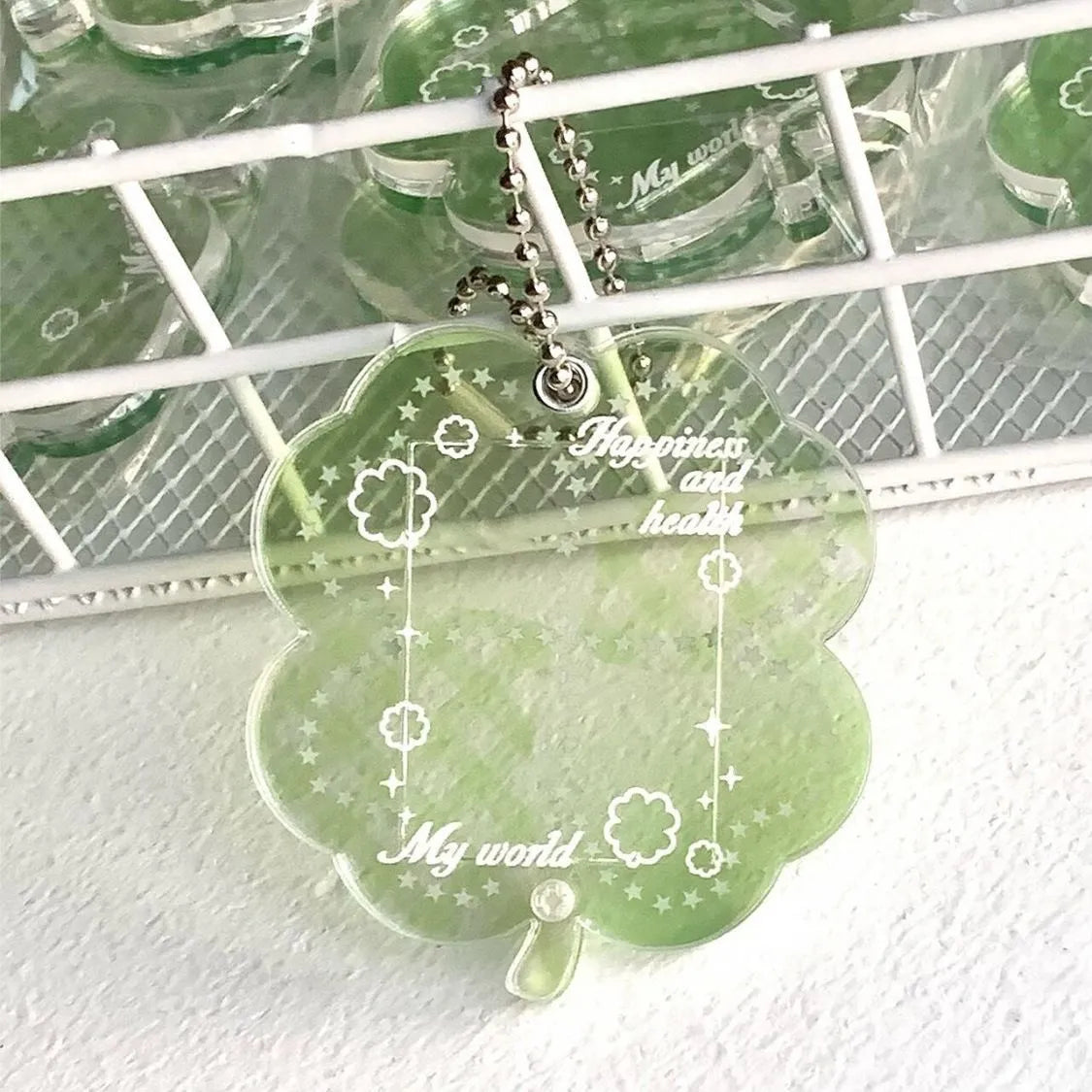 Acrylic four-leaf clover phone pendant keychain on a ring in blue, green, or mint.